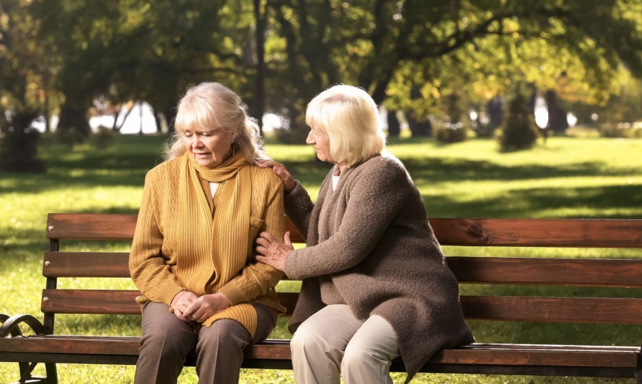 Senior lady comforting old friend about her loss sitting on bench in park 1137647579 3840x2160 2